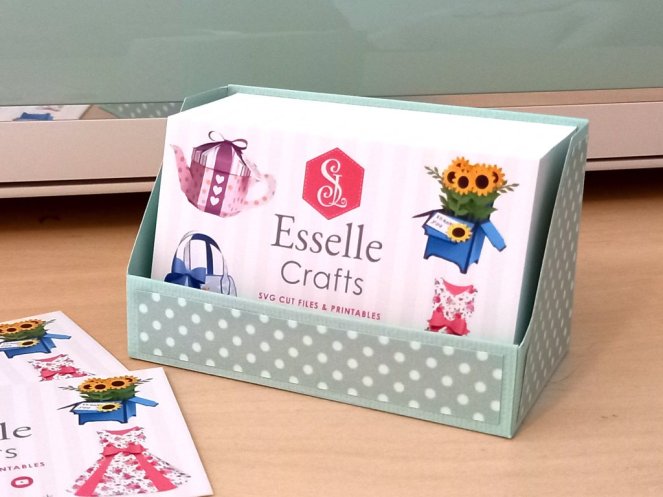 A business card display box made from mint green cardstock and decorated with white spotty card holding 100 business cards.