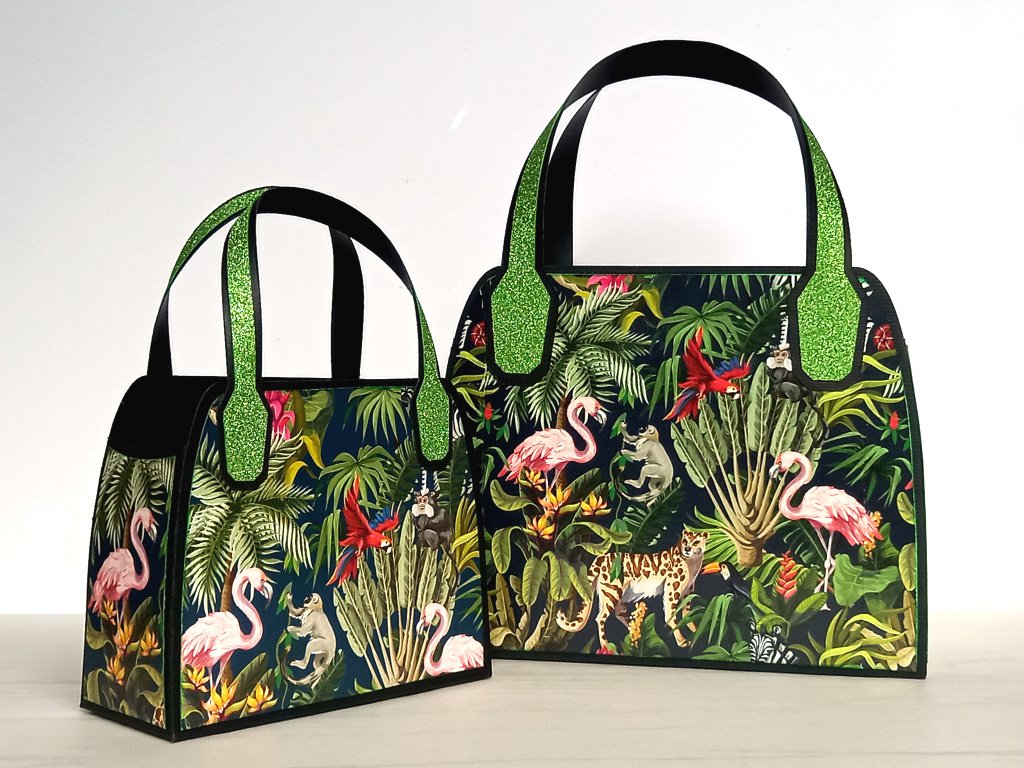 Two black upcycled favour bags with green tropical jungle design