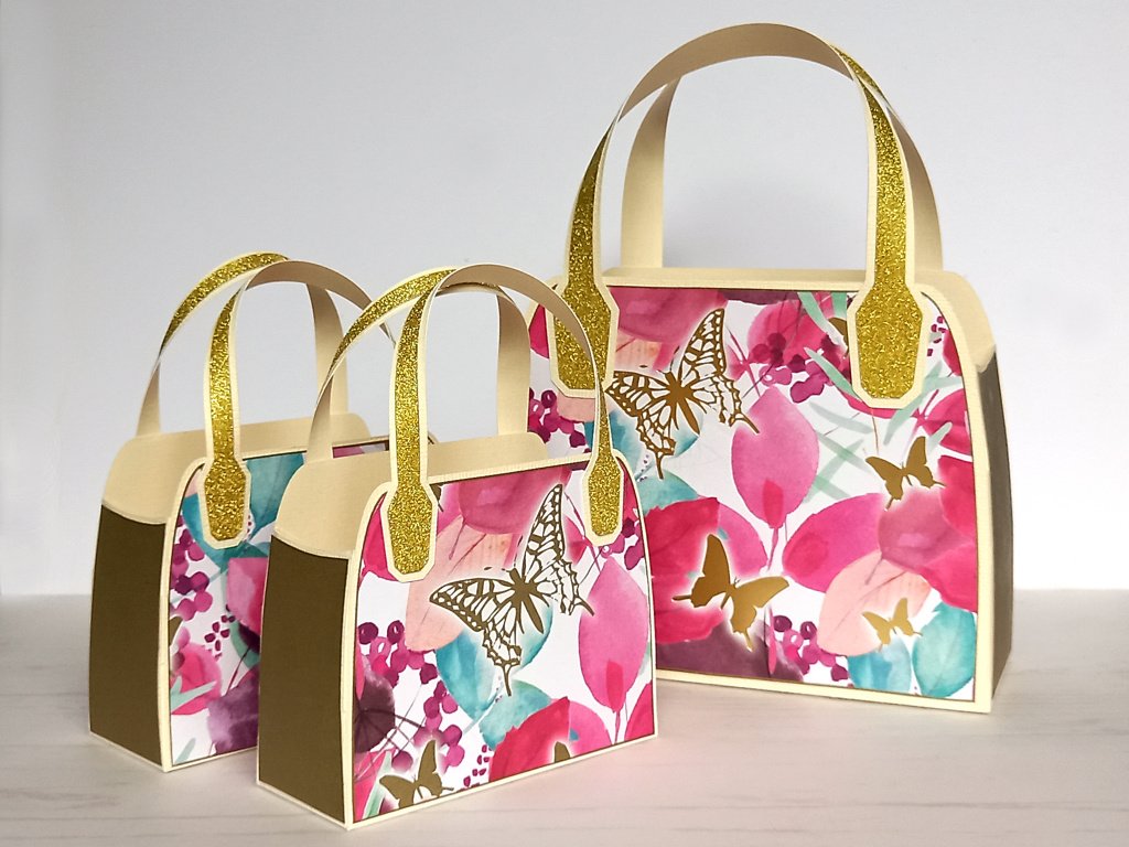 Three pink upcycled favour bags with gold butterfly design