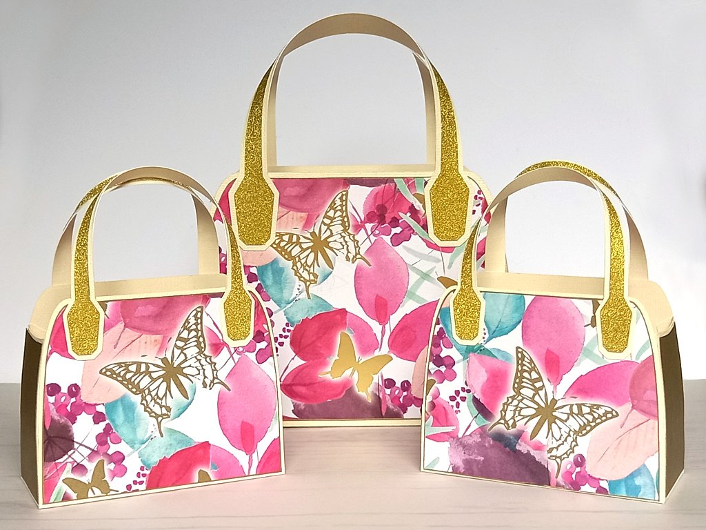 Three pink upcycled favour bags with gold butterfly design