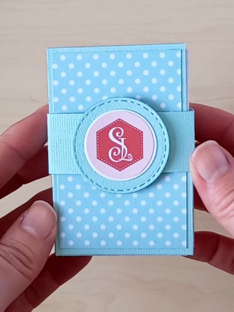 A business card holder made from mint green cardstock and decorated with white spotty card holding 70 business cards.