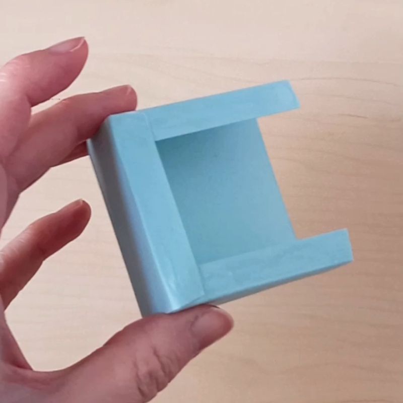 The front of a business card holder made from mint green cardstock