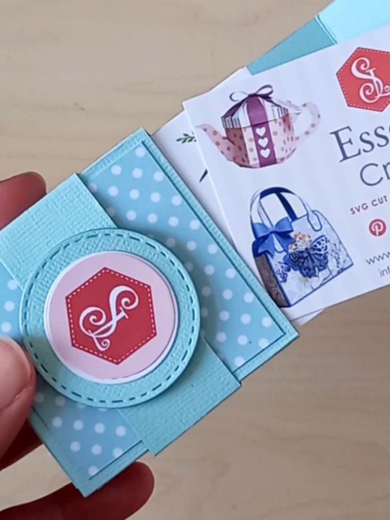 A business card holder made from mint green cardstock and decorated with white spotty card holding 70 business cards.