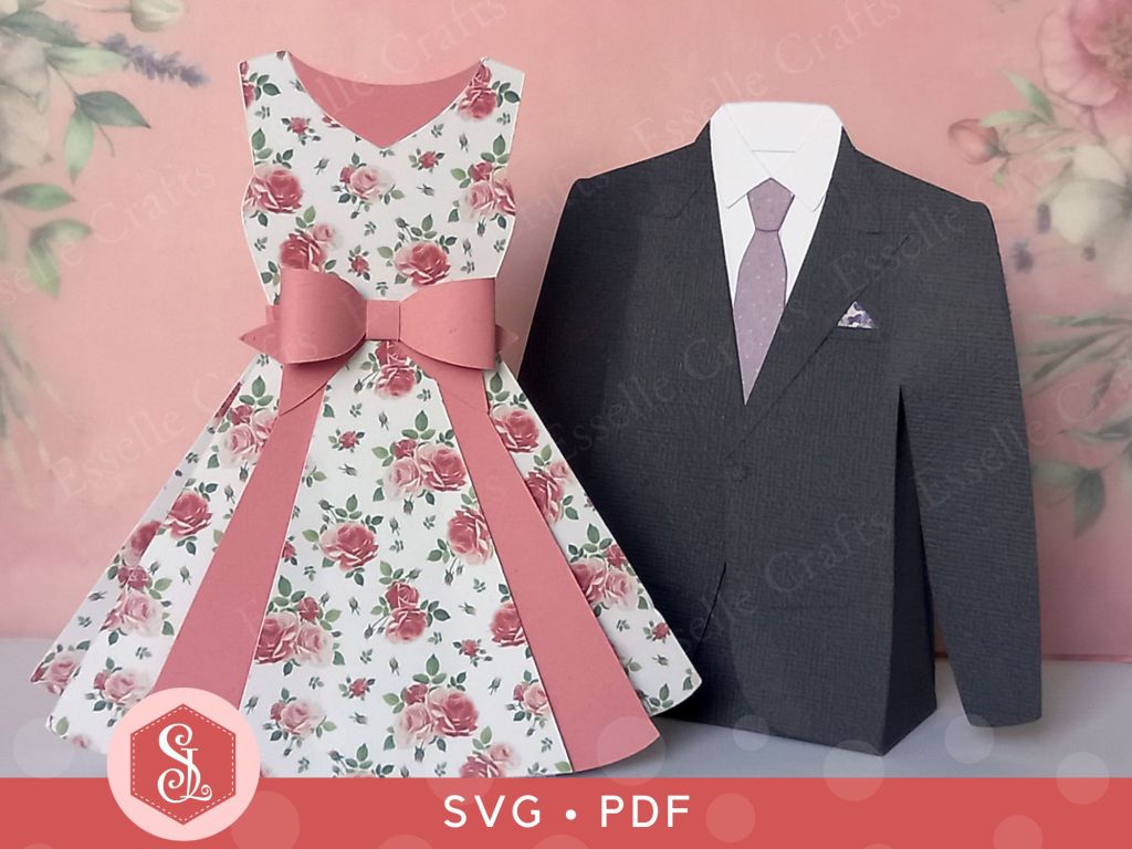 A dark grey paper craft suit jacket favour box with a white shirt a light purple tie and matching handkerchief in the top pocket and a pink papercraft dress favour box with a pretty pink paper bow at the waist