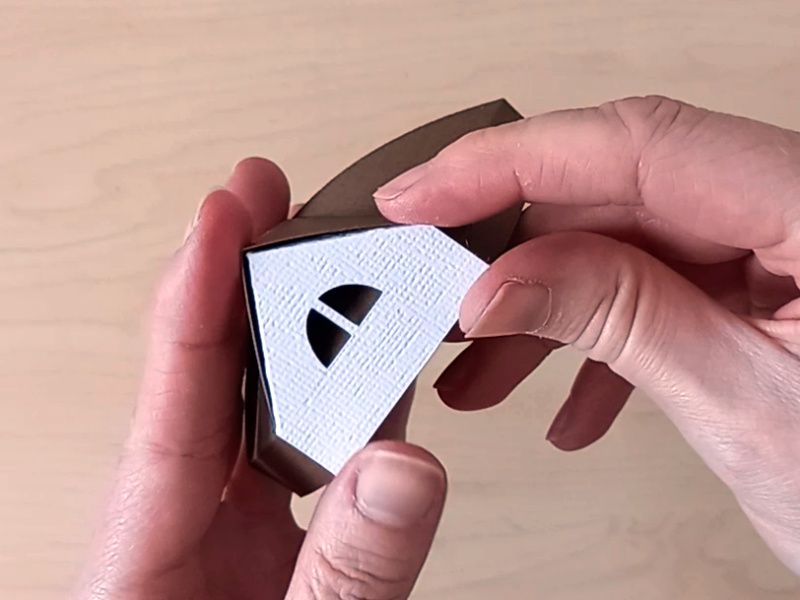 The lid of a 3D paper craft teapot gift box made in the style of a cosy country cottage