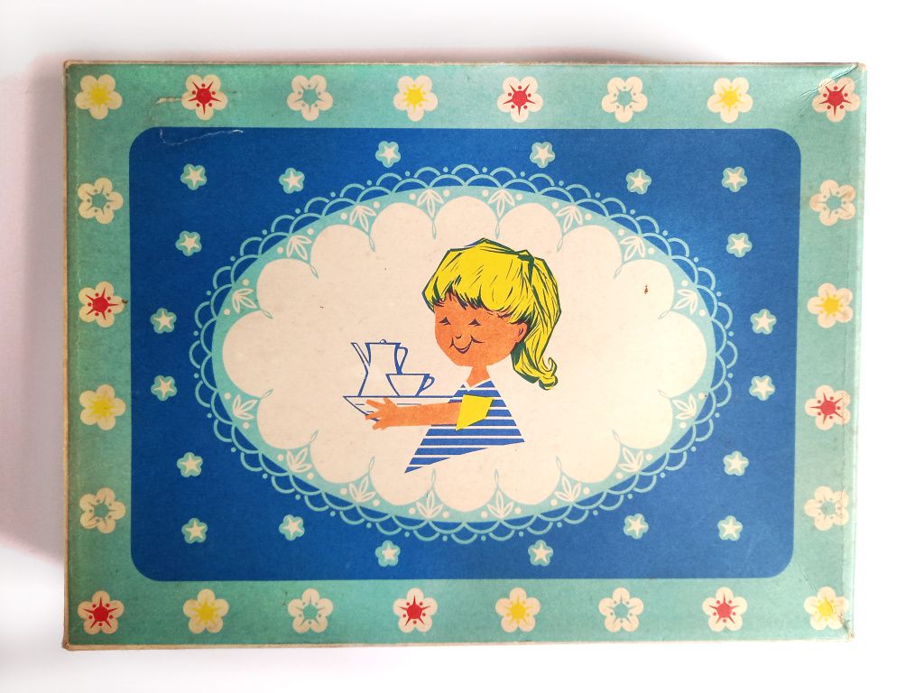 The box lid of a childs vintage ceramic tea set 