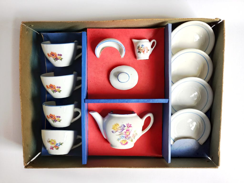 A twelve piece childs vintage ceramic tea set consisting of four teacups four saucers a teapot with a lid a small milk jug and sugar bowl