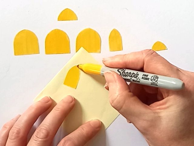 Colouring arched vellum windows with a yellow permanent marker to put onto a paper craft haunted house gift box for Halloween