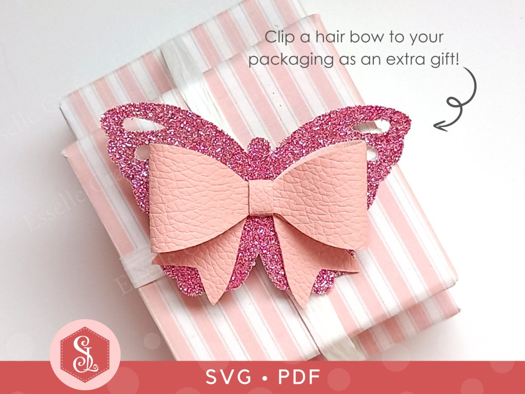 A pink butterfly bow made from faux leather and thin glitter fabric that can be used on a hair clip or head band
