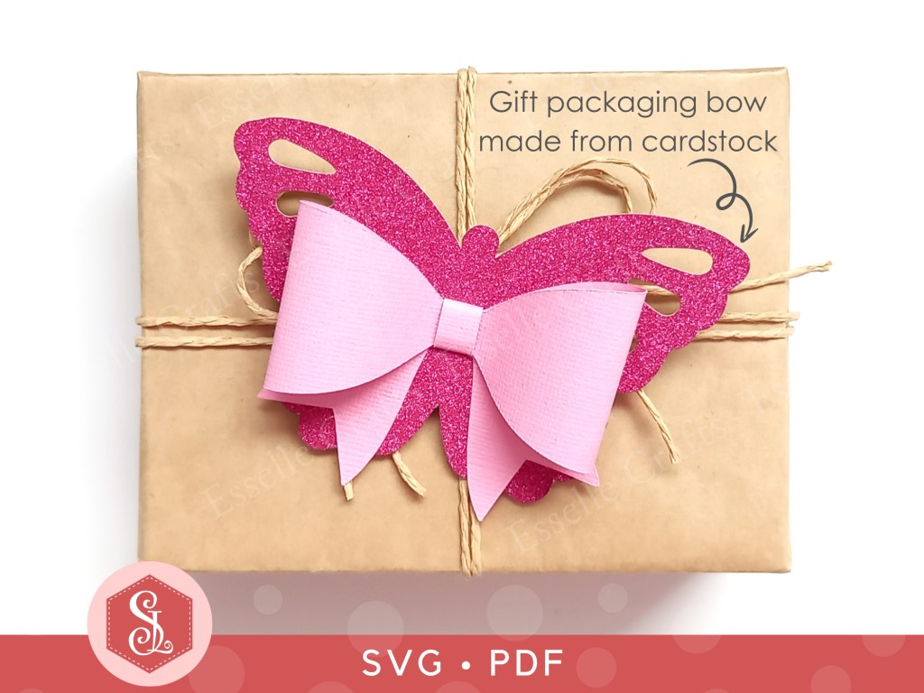 A pink butterfly bow made from textured cardstock that can be used on gift packaging or home decor