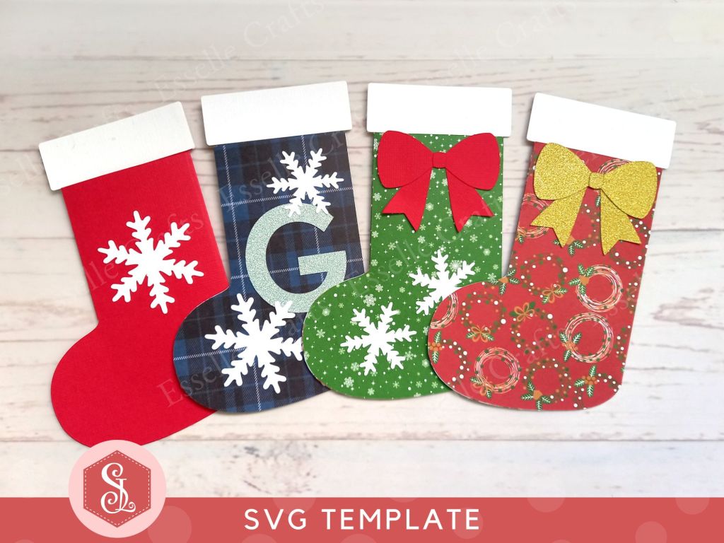 Four festive paper craft gift card holders in the shape of Christmas stockings decorated with snowflakes and bows