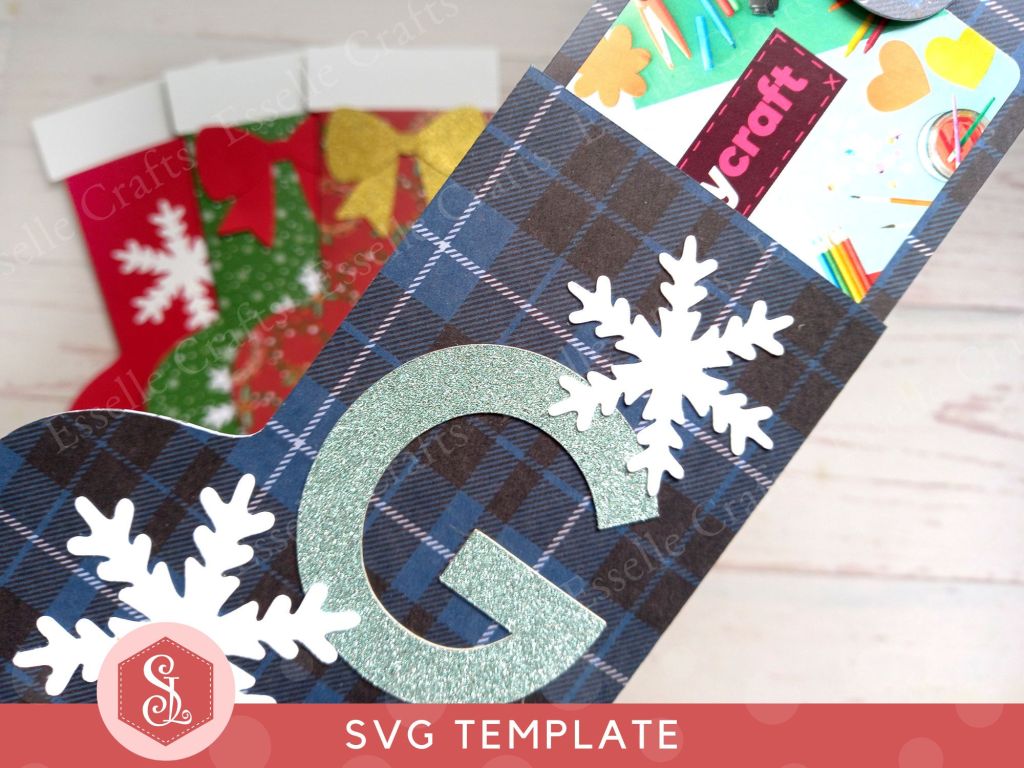 Four festive paper craft gift card holders in the shape of Christmas stockings decorated with snowflakes and bows