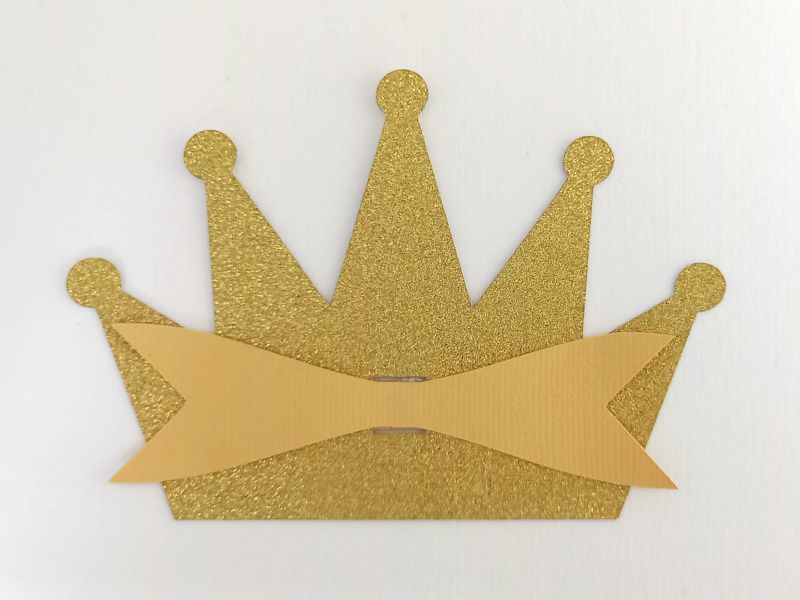 A princess crown bow made from gold glitter cardstock that can be used on gift packaging or home decor