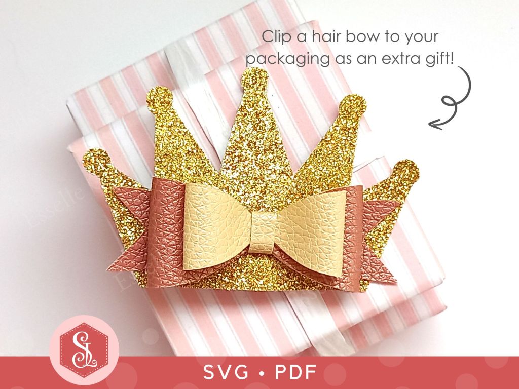 A princess crown bow made from faux leather and thin gold glitter fabric that can be used as a hair bow or a brooch