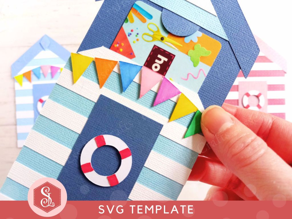 A papercraft gift card holder in the style of a beach hut, decorated with blue and white stripes, a red and white lifebuoy and colourful paper bunting.