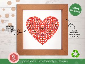 A red mosaic heart design made from small pieces of upcycled paper packaging, framed in a square brown kraft card frame.