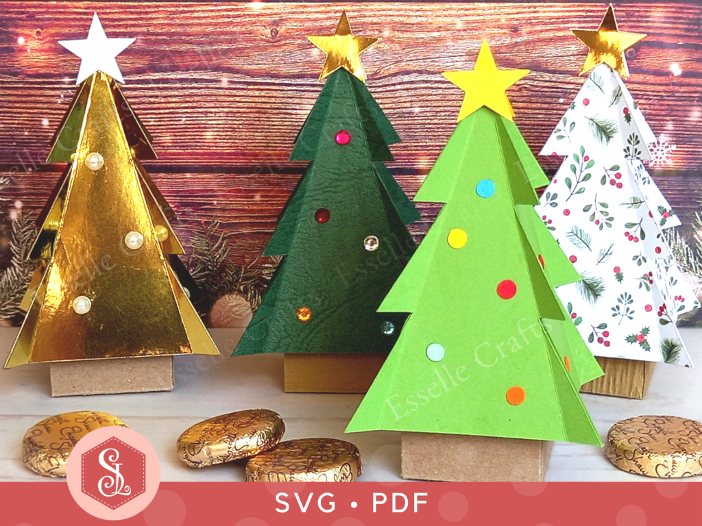 Four papercraft Christmas tree favour boxes, one light green, one dark green, one white and one gold, all with gold star toppers. Perfect for filling with sweets or small treats.