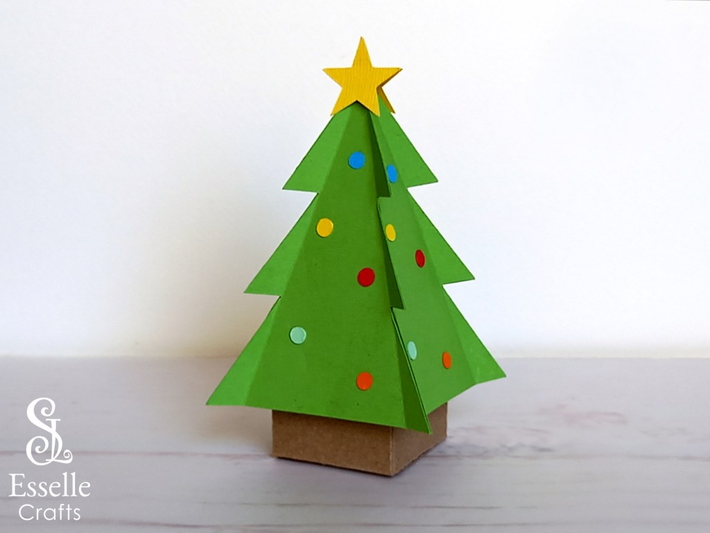 A papercraft Christmas tree favour box with a gold star topper. Perfect for filling with sweets or small treats.