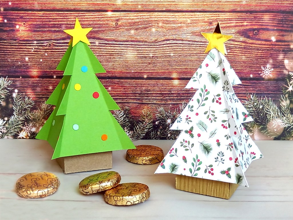 Two papercraft Christmas tree favour boxes. Perfect for filling with sweets or small treats.