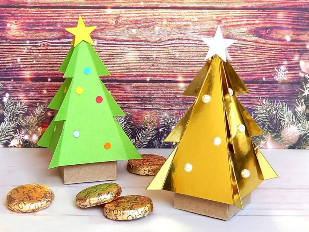Two papercraft Christmas tree favour boxes. Perfect for filling with sweets or small treats.