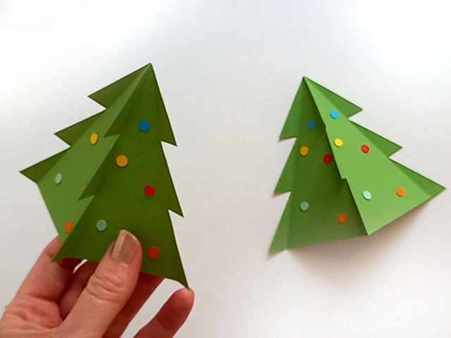 Two papercraft Christmas tree favour boxes. Perfect for filling with sweets or small treats.