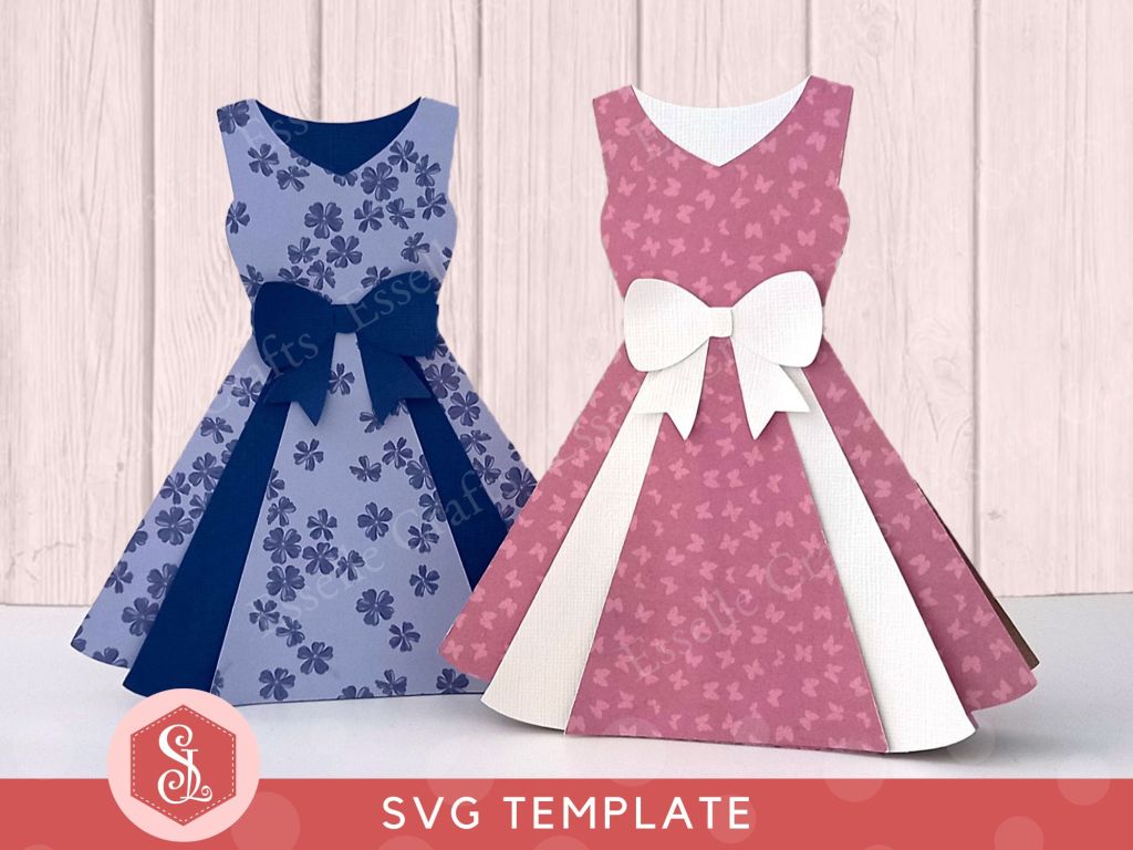 A papercraft gift card holder in the style of a vintage pink dress. It is decorated with a white paper bow round the waist and white paper panels on the front.