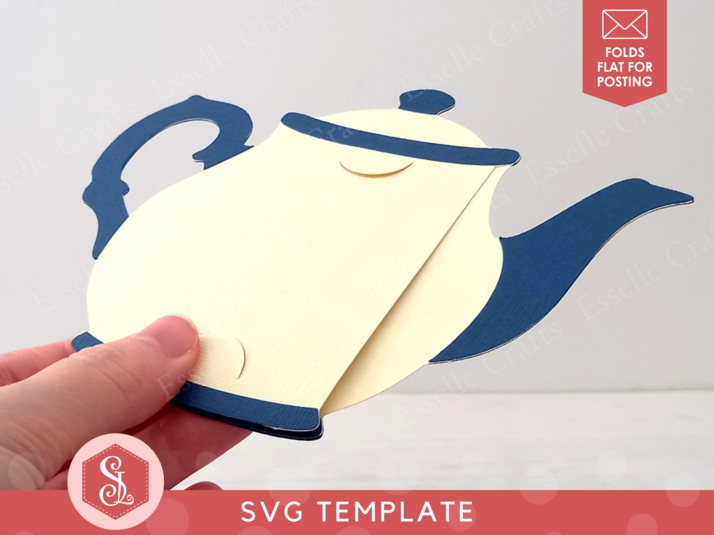 A papercraft gift card holder in the style of a vintage cream teapot with a dark blue handle and spout.