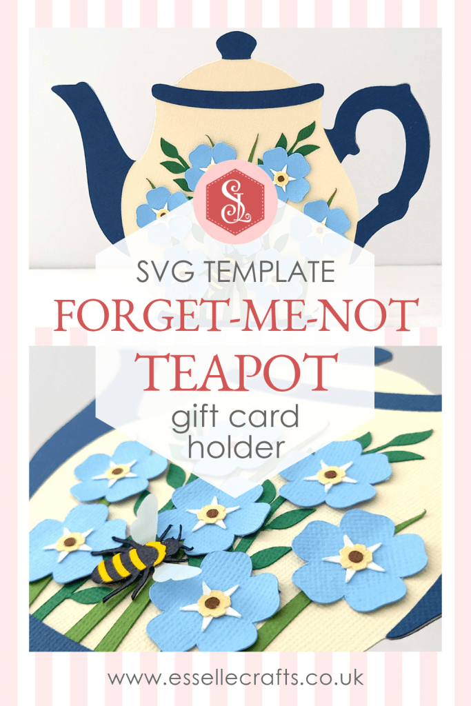 A papercraft gift card holder in the style of a vintage cream teapot with a dark blue handle and spout. It is decorated with light blue paper forget-me-not flowers on the front.