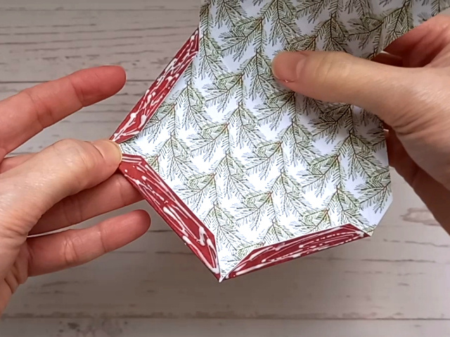 Making a red papercraft star treat box from a template.