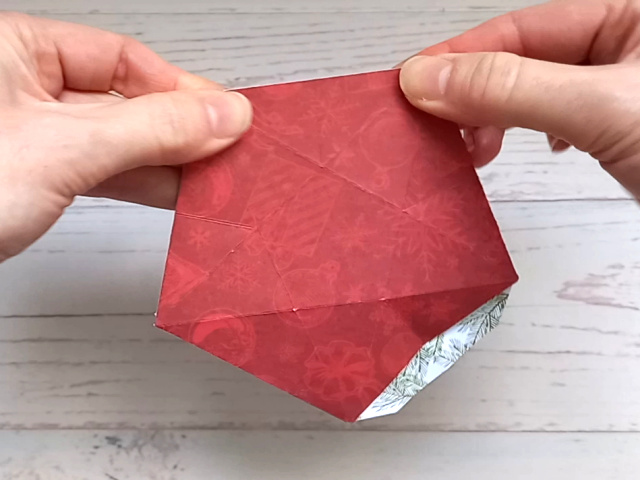 Making a red papercraft star treat box from a template.