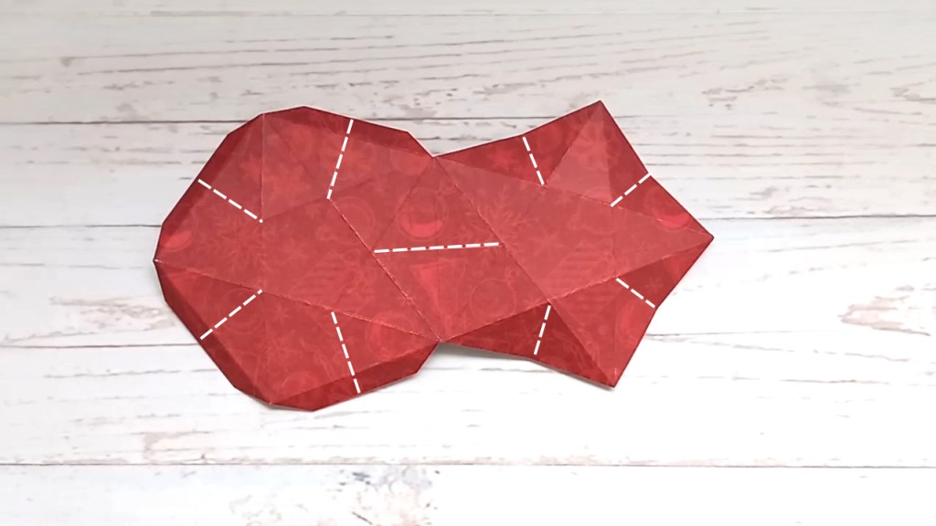 Making a red papercraft star treat box from a template.