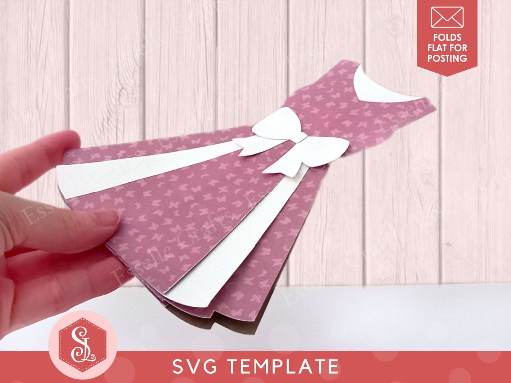 A papercraft gift card holder in the style of a vintage pink dress. It is decorated with a white paper bow round the waist and white paper panels on the front.