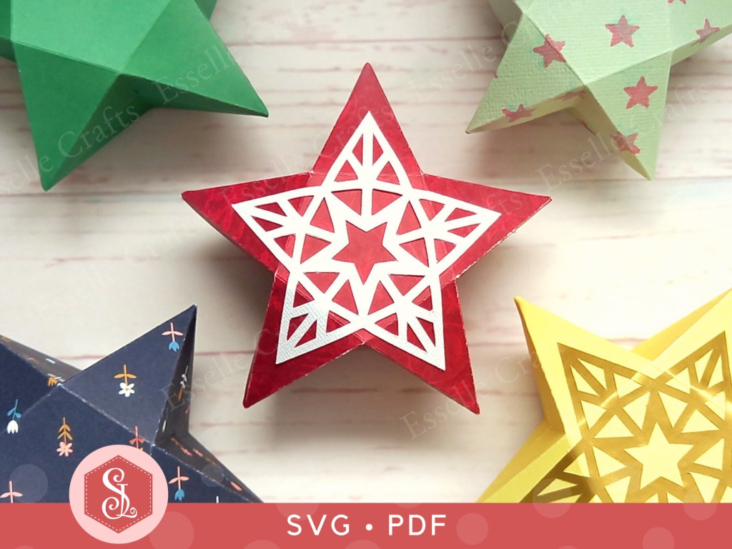 A red papercraft favour box in the shape of a star with a white decorative panel on top used for gifting sweets or small treats.