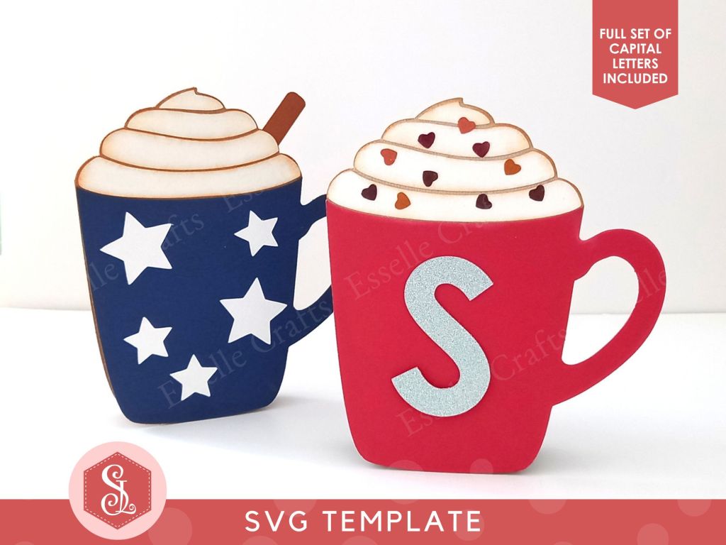 Two papercraft gift card holders in the shape of a cosy Christmas mug. One is dark blue decorated with white paper stars and one is dark red decorated with a silver letter S.