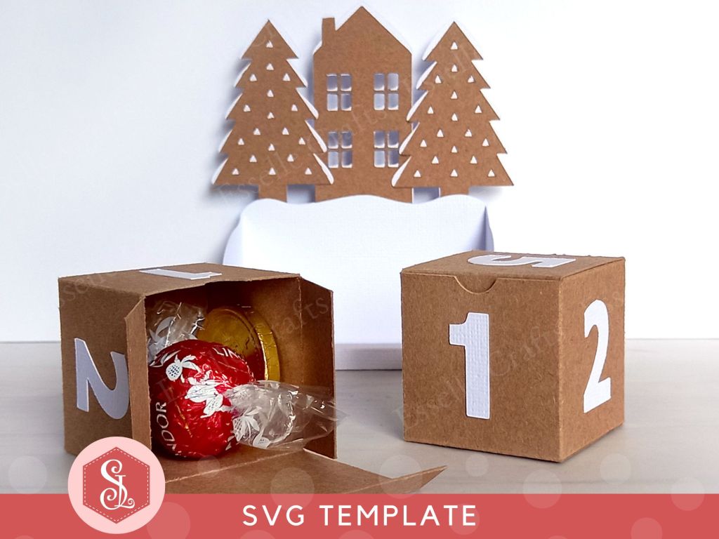 A Christmas countdown advent calendar, which comes as a DIY papercraft template, featuring a central house, two pine trees, and two numbered blocks that double up as gift boxes. It can be refilled and reused each year.